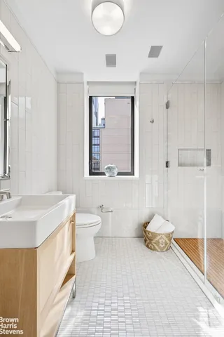a bathroom with a sink toilet and shower