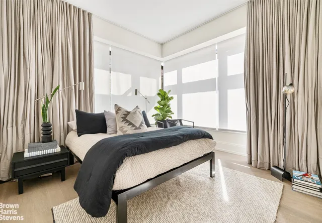 a living room with a bed furniture and a window