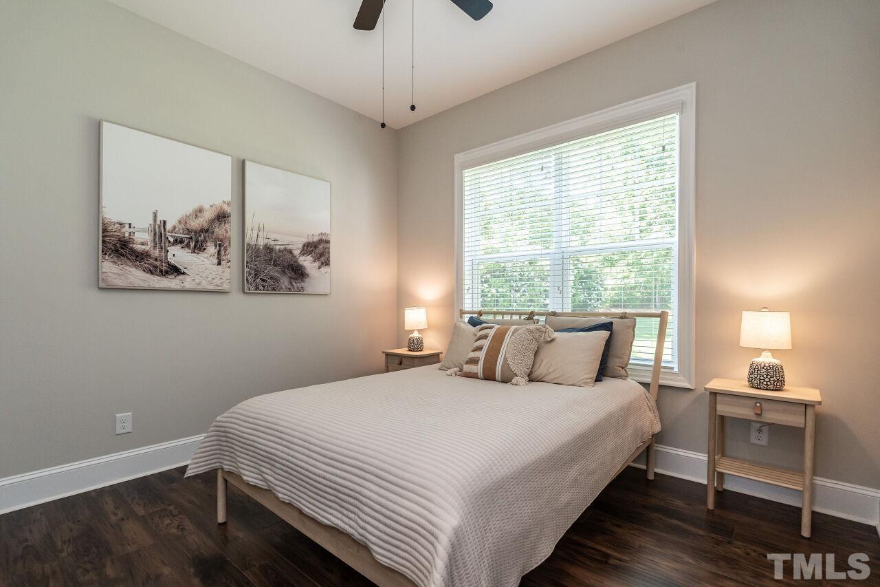3034 Adonis Circle Raleigh, NC 27612 - Photo 22 of 46 a bedroom with a large bed and a window