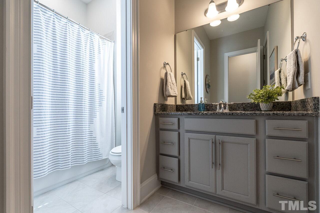 3034 Adonis Circle Raleigh, NC 27612 - Photo 23 of 46 a bathroom with a sink and a mirror