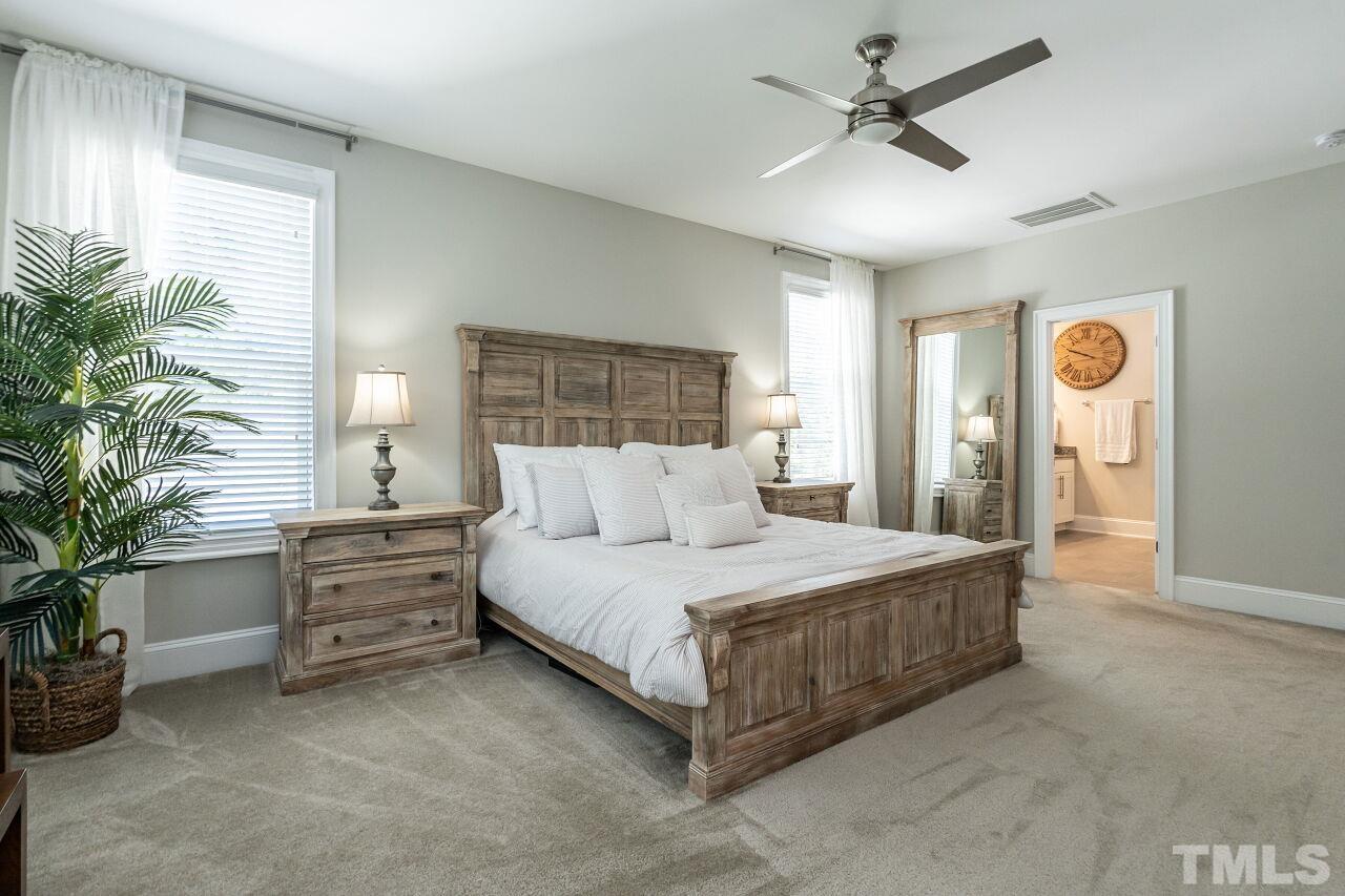 3034 Adonis Circle Raleigh, NC 27612 - Photo 26 of 46 a room with a bed and ceiling fan