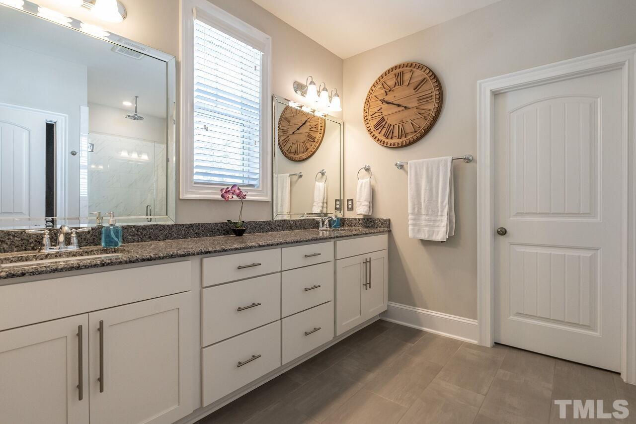 3034 Adonis Circle Raleigh, NC 27612 - Photo 27 of 46 a bathroom with a sink and a large mirror