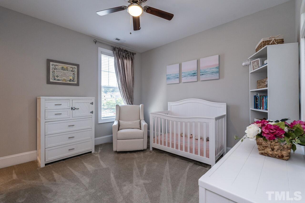 3034 Adonis Circle Raleigh, NC 27612 - Photo 30 of 46 a bedroom with furniture and a baby crib
