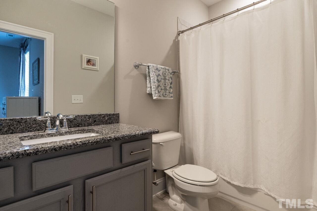 3034 Adonis Circle Raleigh, NC 27612 - Photo 31 of 46 a bathroom with a granite countertop sink and a mirror