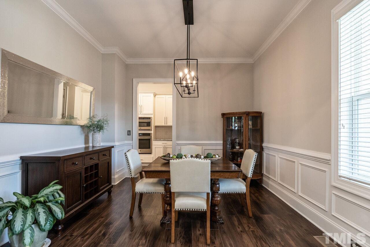 3034 Adonis Circle Raleigh, NC 27612 - Photo 6 of 46 a view of a dining room with furniture a chandelier and wooden floor