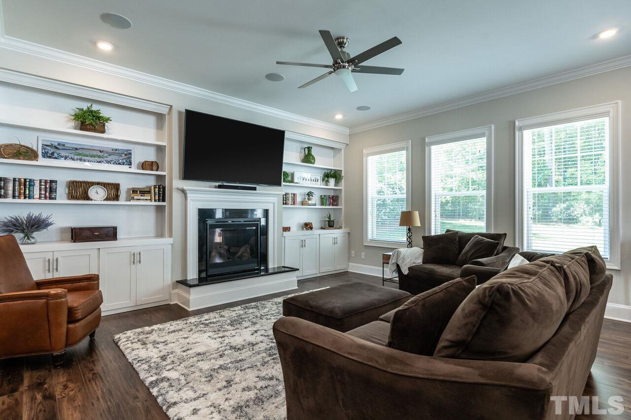 3034 Adonis Circle Raleigh, NC 27612 - Photo 8 of 46 a living room with furniture fireplace and flat screen tv