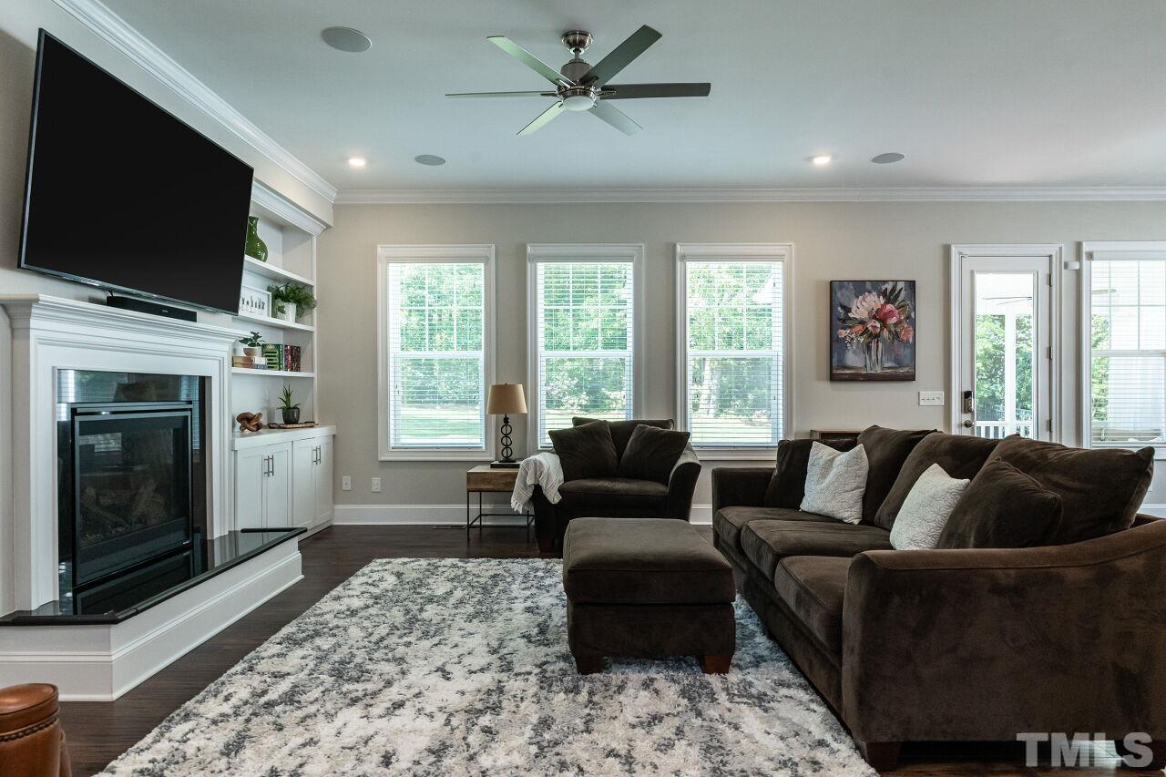 3034 Adonis Circle Raleigh, NC 27612 - Photo 9 of 46 a living room with furniture a flat screen tv and a fireplace