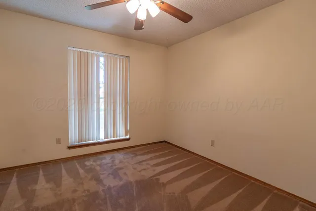 a view of a street with a couple of cars parked in front of a house