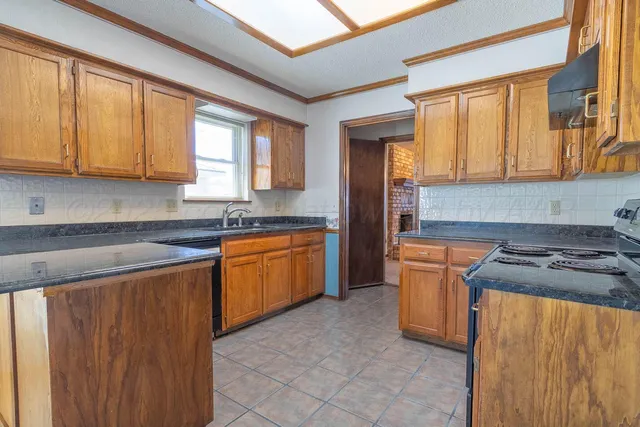 a bathroom with a granite countertop toilet and a sink