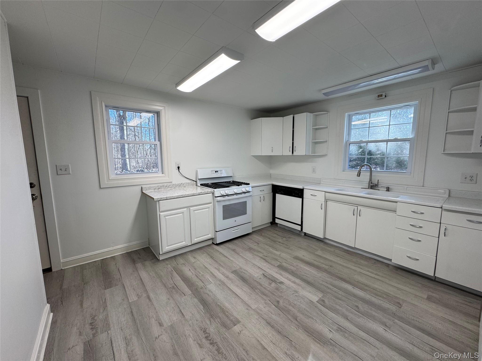 68 Chapel Road Newburgh, NY 12550 - Photo 14 of 17 a kitchen with white cabinets and white appliances
