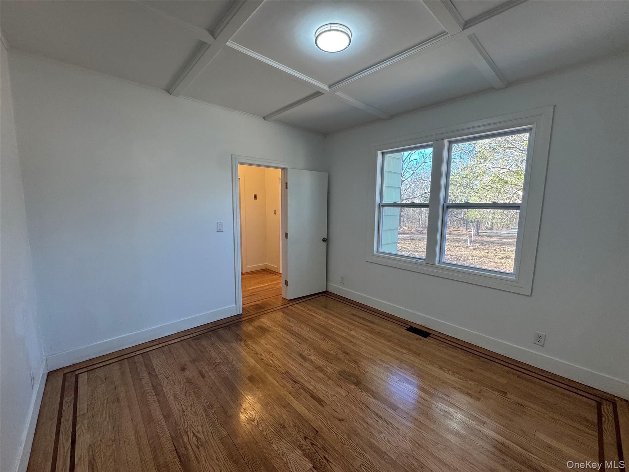 68 Chapel Road Newburgh, NY 12550 - Photo 6 of 17 an empty room with wooden floor and windows