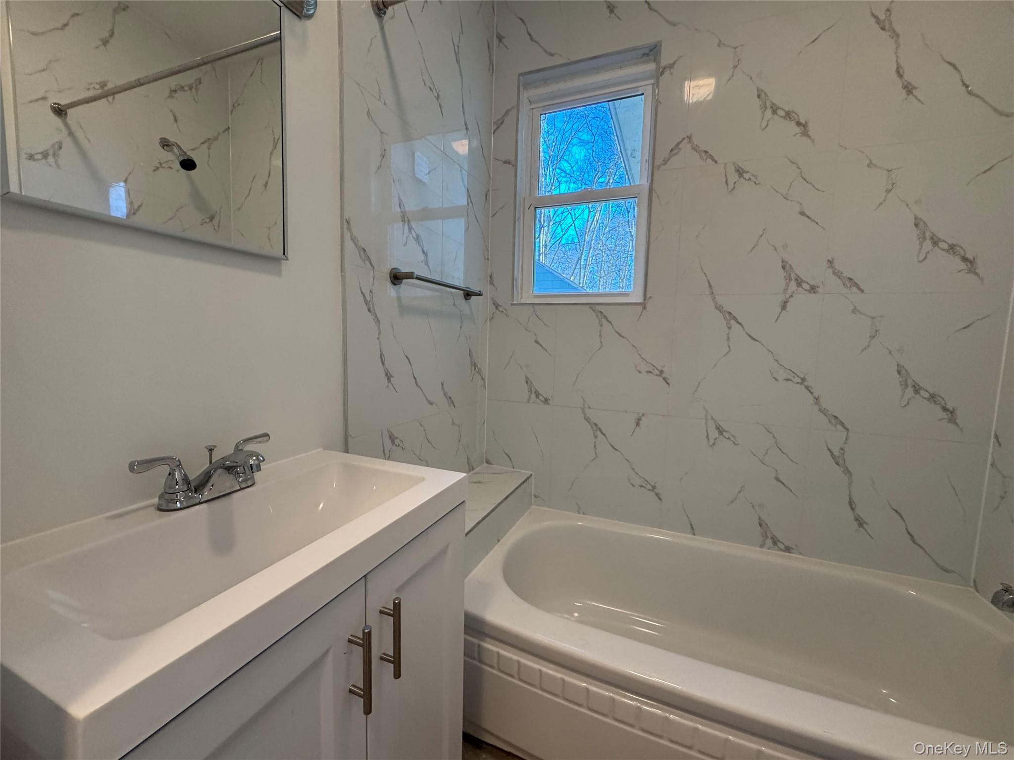 68 Chapel Road Newburgh, NY 12550 - Photo 10 of 17 a bathroom with a sink and a bathtub