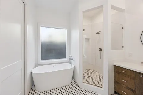 a bathroom with a bathtub a sink and a shower