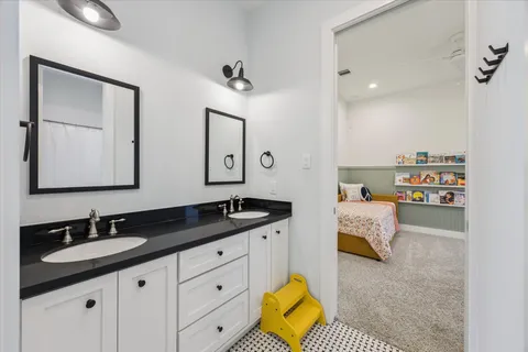 a en suite bathroom with double sink and a mirror