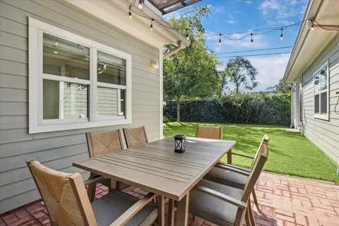 a view of a patio with table and chairs