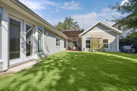 a view of a house with a backyard