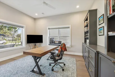 a view of a workspace with furniture and a window