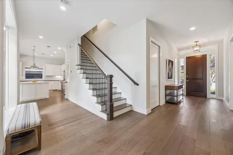 a view of a kitchen with wooden floor and electronic appliances