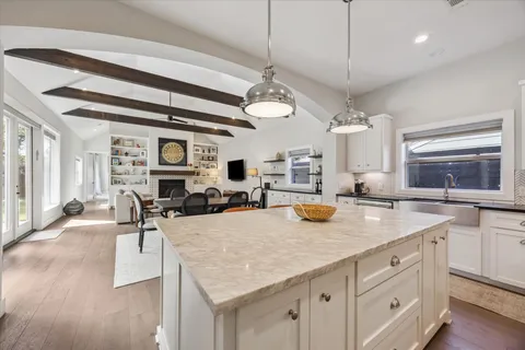 a kitchen with sink cabinets and living room view