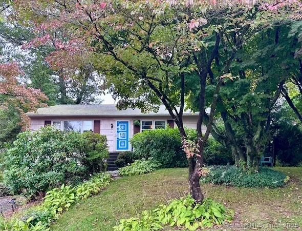 front view of a house with a tree