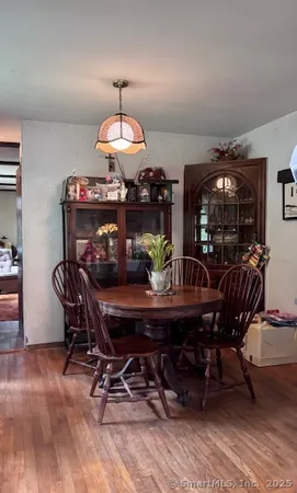 a view of a dining room with furniture and chandelier