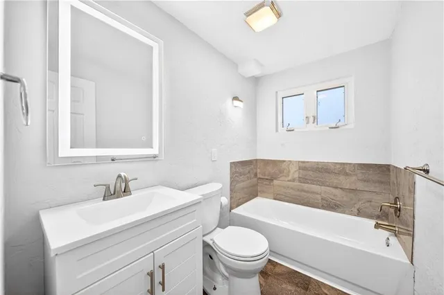 a bathroom with a sink a toilet and a bathtub