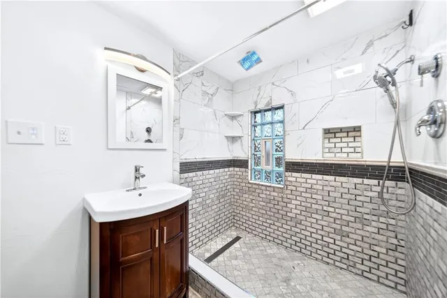 a bathroom with a sink a toilet and a mirror