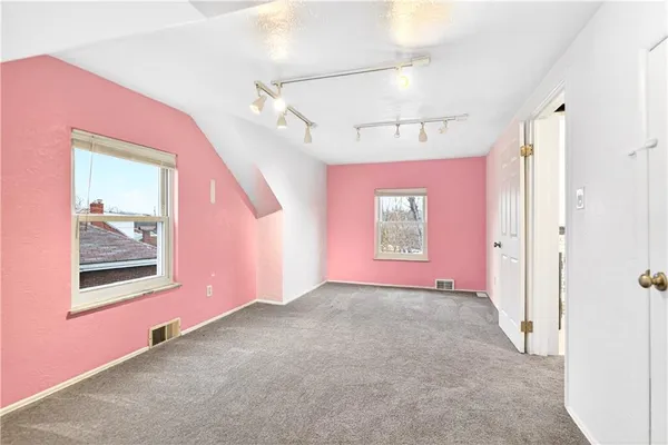 an empty room with windows and closet