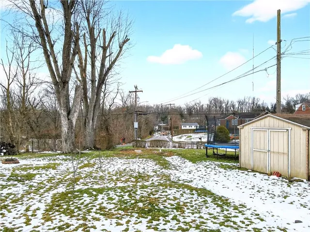 a view of a lake with a house and a big yard