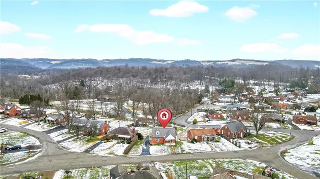aerial view of a house with yard swimming pool and outdoor seating