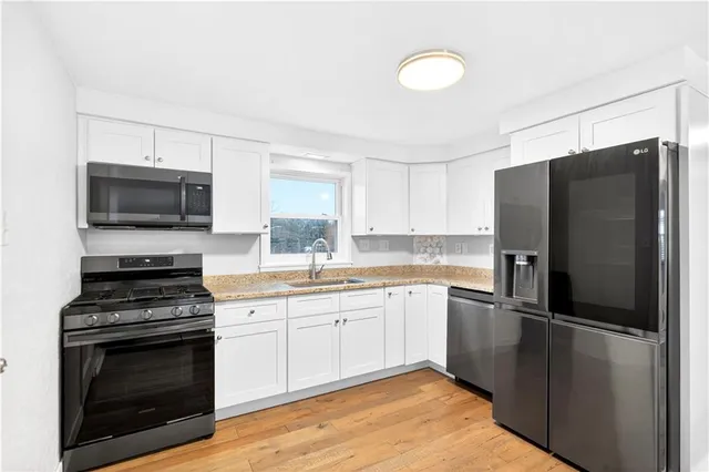 a kitchen with a sink stove and microwave
