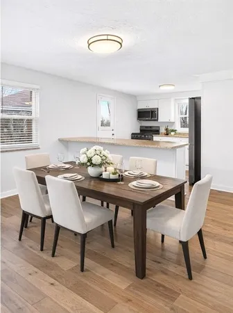 a view of a dining room with furniture and wooden floor