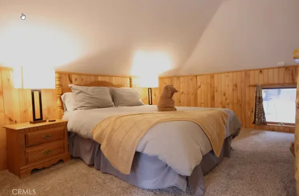a bedroom with a bed and cabinets