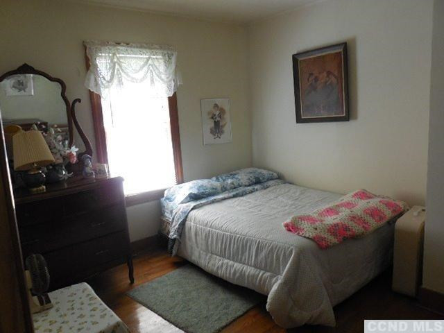 266 Birch Hill Road Copake, NY 12521 - Photo 19 of 21 a bedroom with a bed and wooden floor