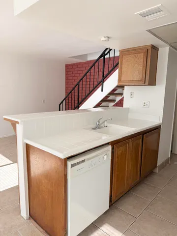 a utility room with cabinets washer and dryer
