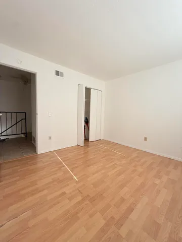 a view of an empty room and wooden floor