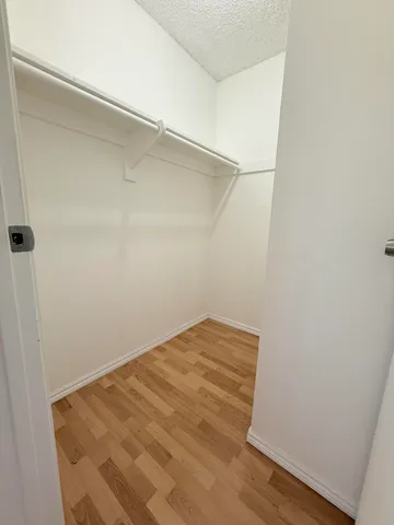 a view of a room with wooden floor