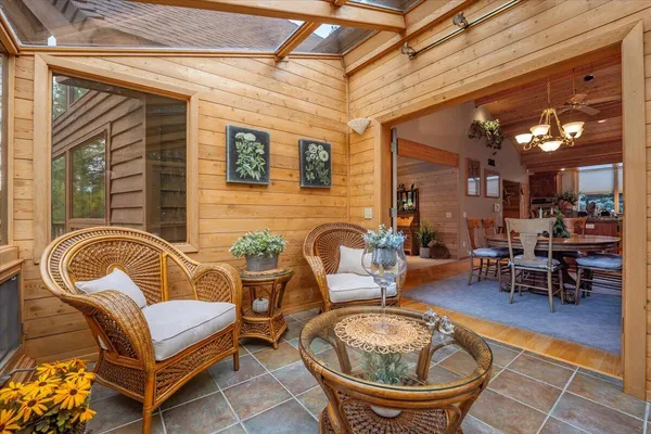 a dining room with furniture window and wooden floor