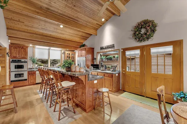 a kitchen with sink and mirror