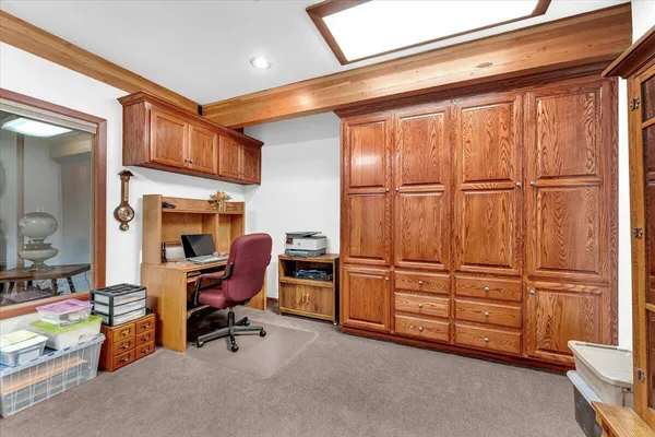 a spacious bedroom with a bed a couch and a chandelier