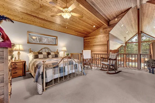 a bedroom with a bed a table and chairs