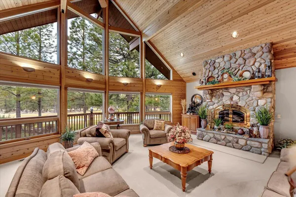 a living room with patio furniture and a floor to ceiling window