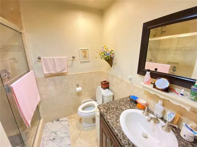 a bathroom with a sink mirror vanity and toilet