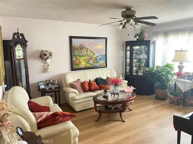 a living room with furniture and flowers