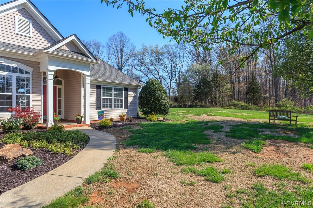 102 West Ridge Court Keswick, VA 22947 - Photo 5 of 48 a front view of a house with a yard and trees