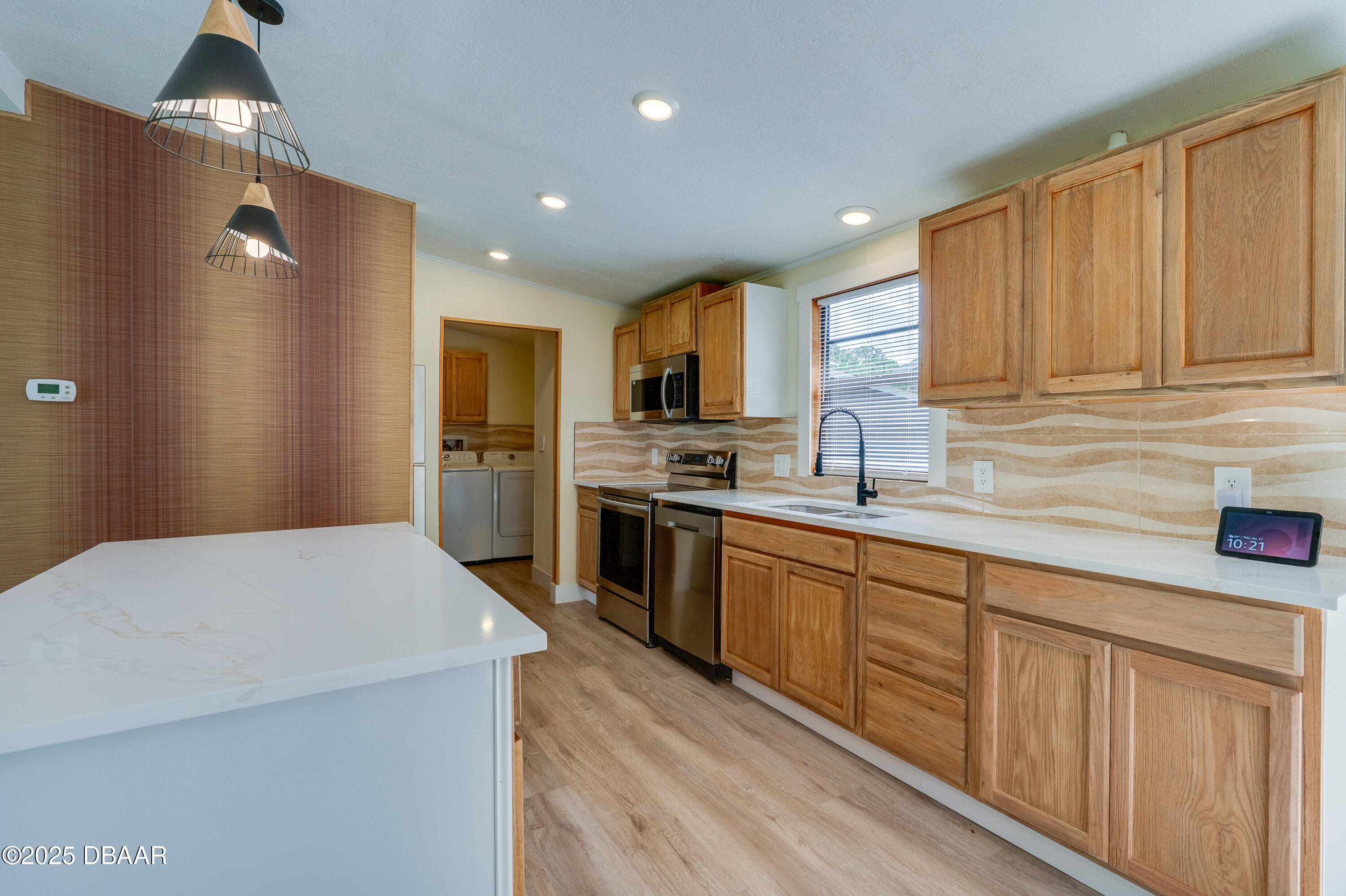 3669 General Marshall Road Daytona Beach, FL 32124 - Photo 13 of 32 a kitchen with granite countertop a refrigerator stove top oven and sink