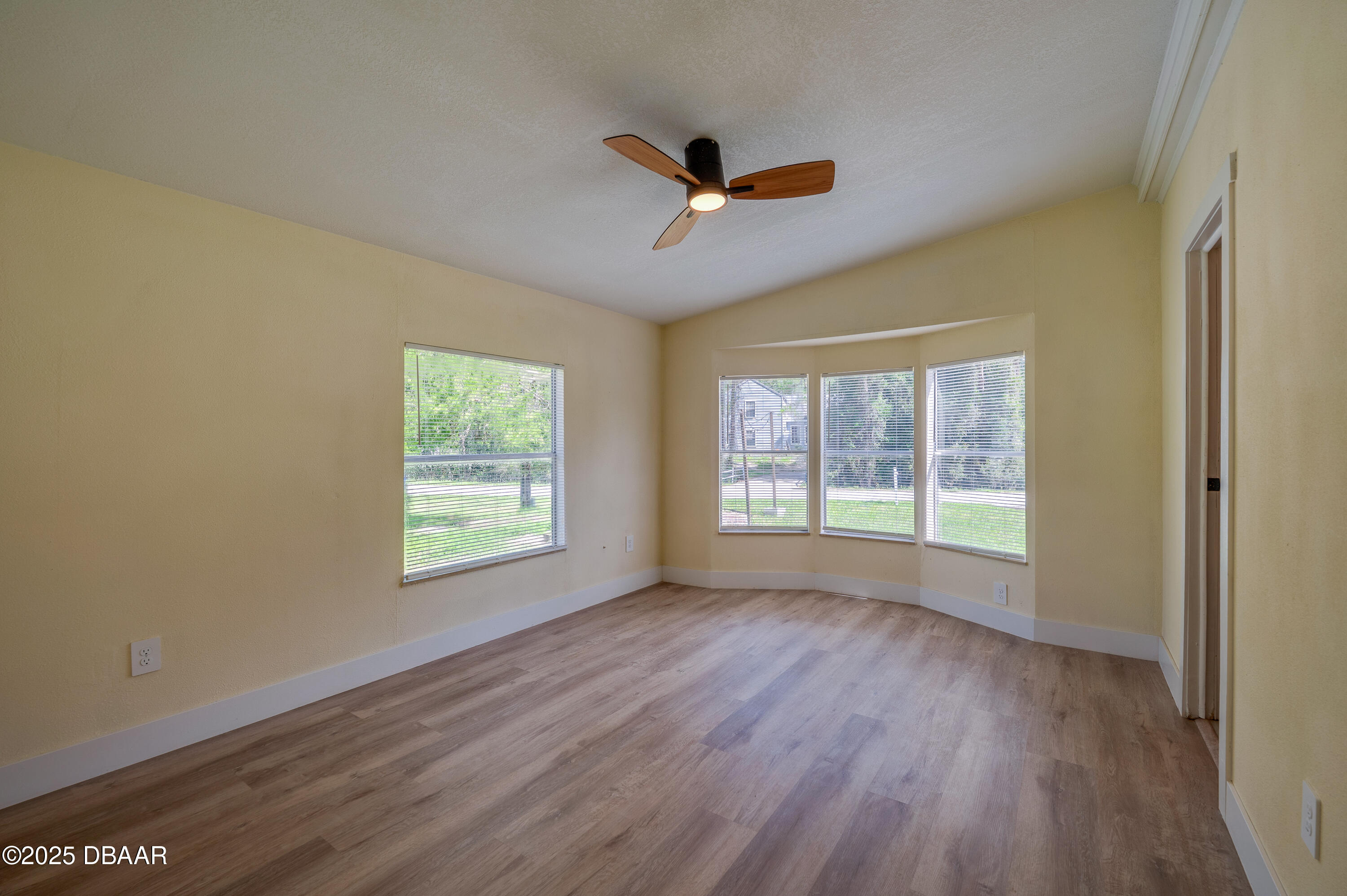 3669 General Marshall Road Daytona Beach, FL 32124 - Photo 17 of 32 a view of an empty room with wooden floor and a window