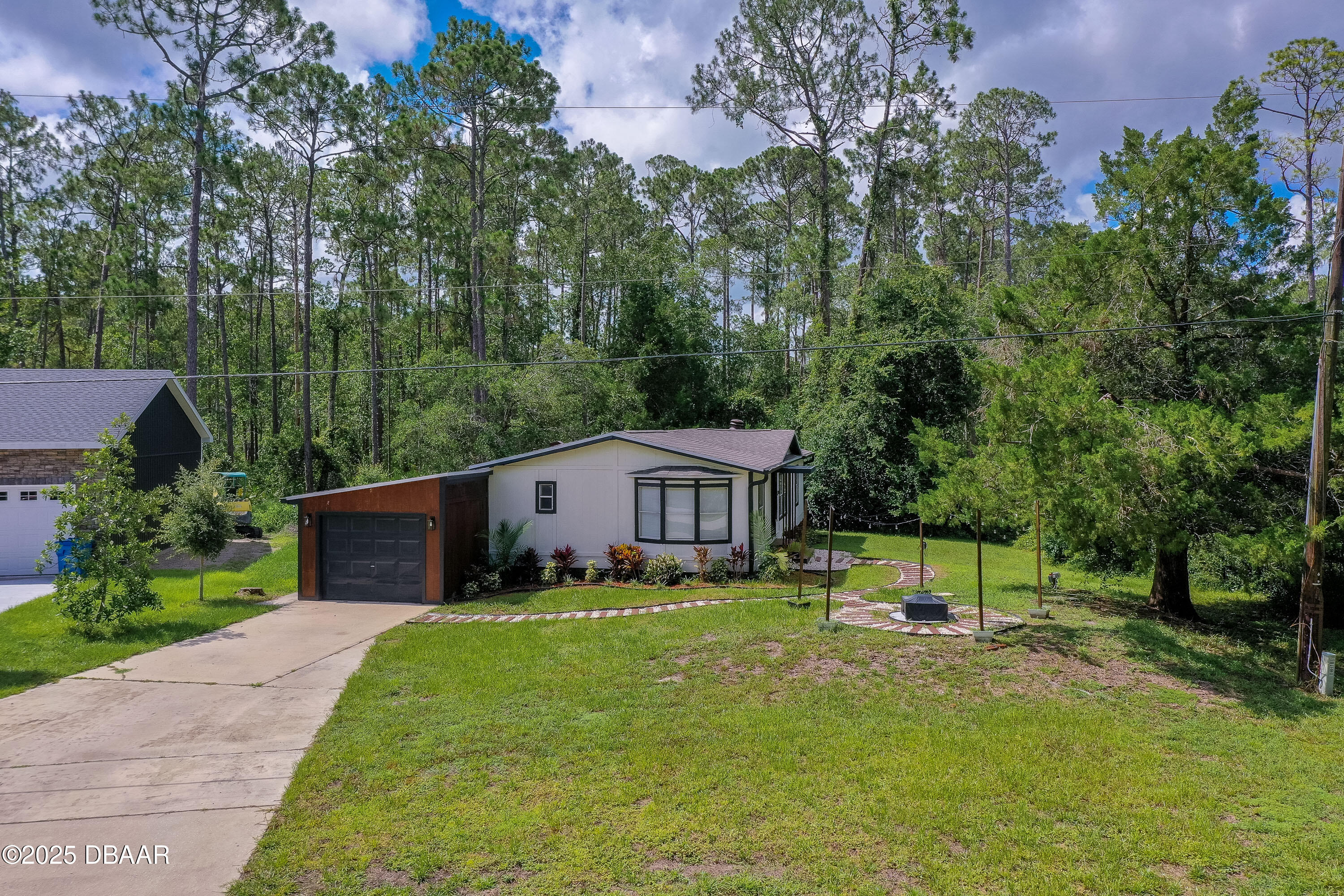 3669 General Marshall Road Daytona Beach, FL 32124 - Photo 2 of 32 a view of a house with a yard and sitting area
