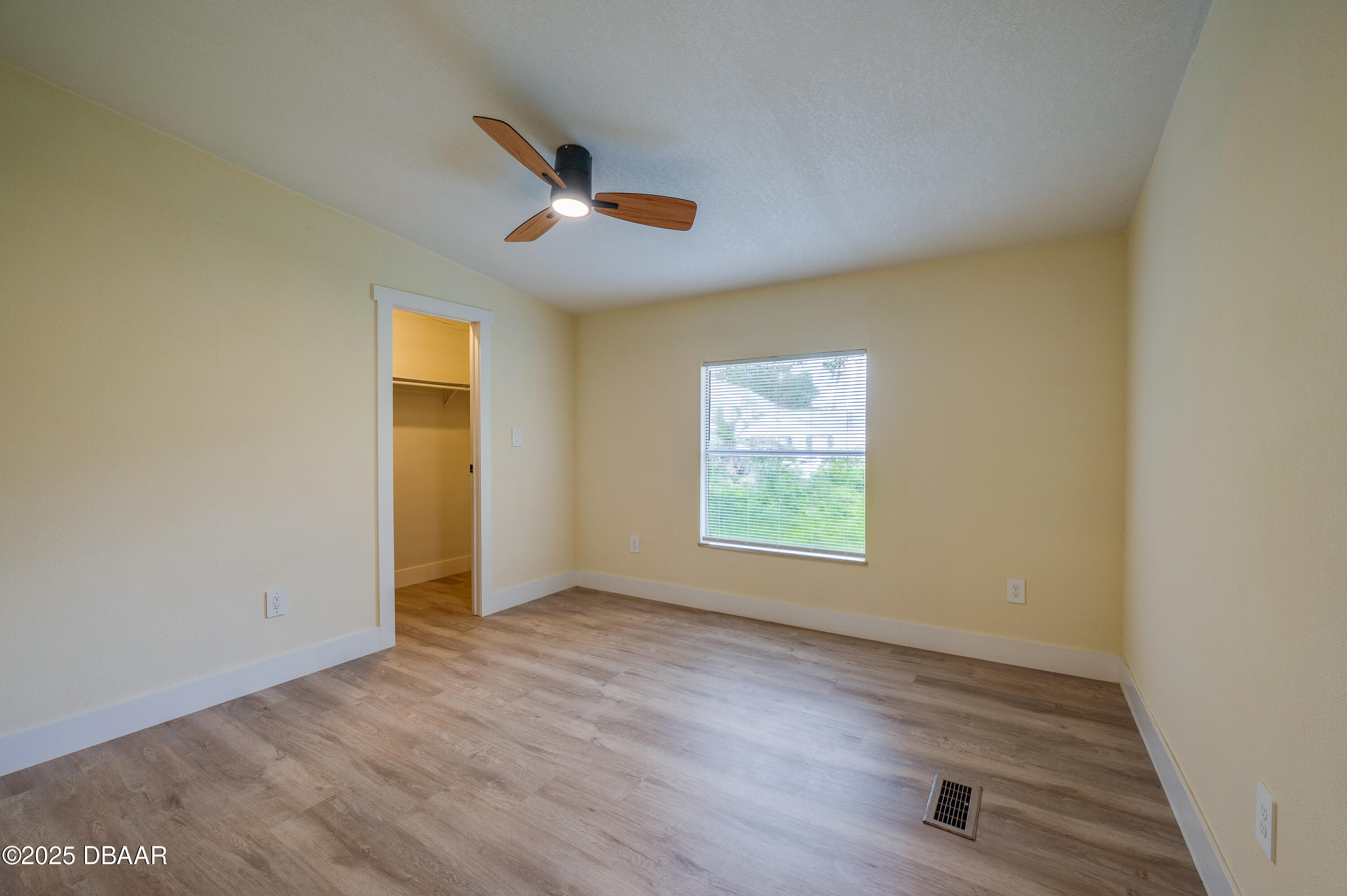 3669 General Marshall Road Daytona Beach, FL 32124 - Photo 21 of 32 an empty room with wooden floor fan and windows