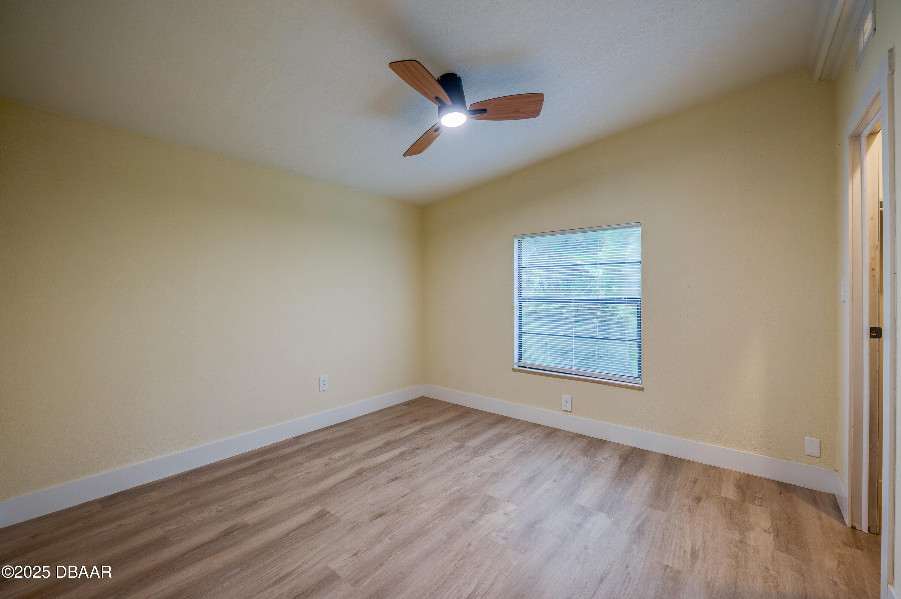 3669 General Marshall Road Daytona Beach, FL 32124 - Photo 24 of 32 a view of an empty room with wooden floor and a window
